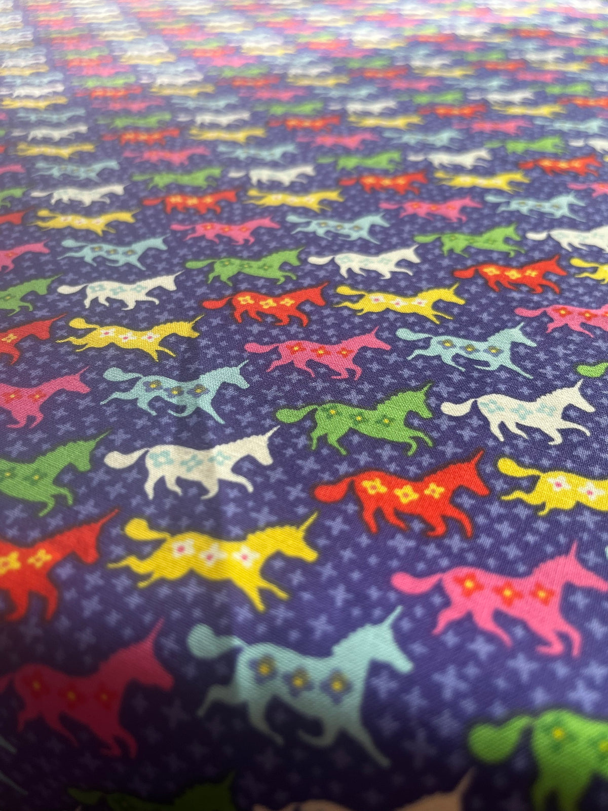 Close-up of Scandi Unicorns print on purple