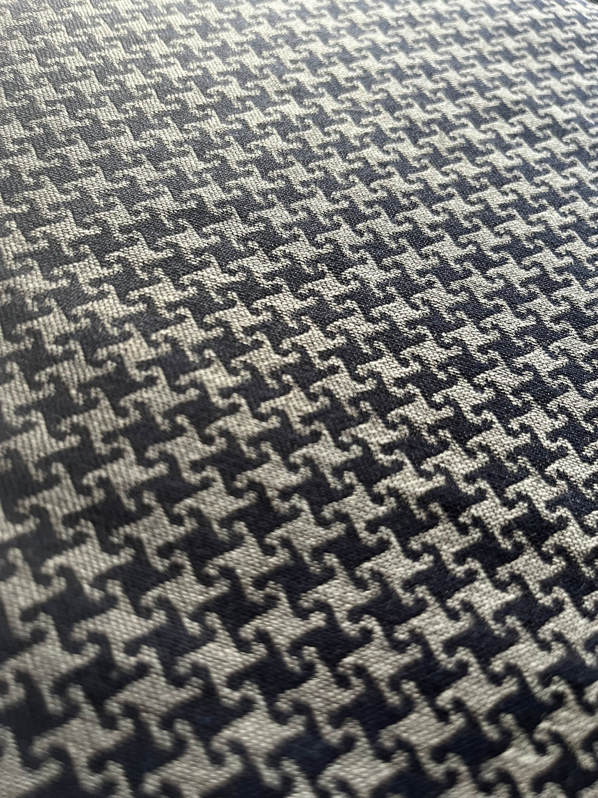 Close-up of Cheeky Houndstooth cloth in grey and navy